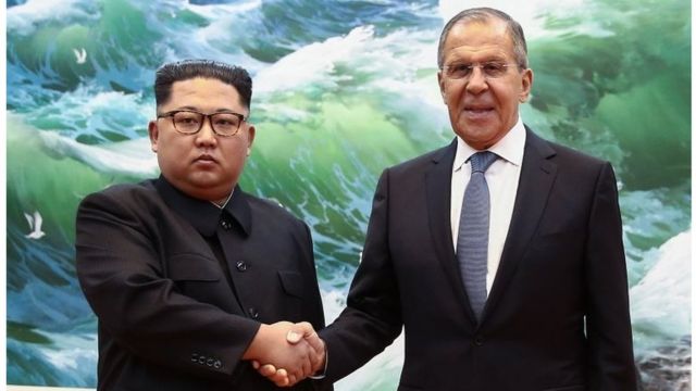 Russian Foreign Minister Sergei Lavrov (R) shakes hands with North Korean leader Kim Jong-un during a meeting in Pyongyang on May 31, 2018