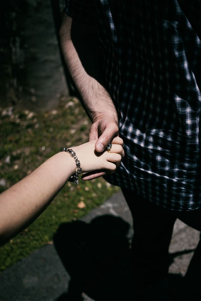 A man and a woman hold hands