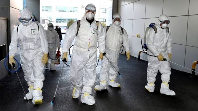 Workers disinfecting a street