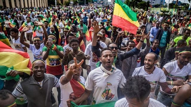 Ethiopians wave national flags and celebrate in the streets of Addis Ababa