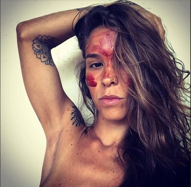 Morena Cardoso, terapeuta e escritora de 34 anos, com o rosto coberto com sangue de menstruação.