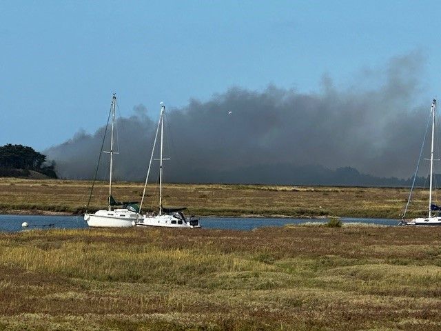 Smoke from the fire at East Hills and boats in an estuary