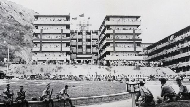 Hong Kong riot police rested at the junction of Tai Po Road and Castle Peak Road in front of Mei Ho House in Shek Kip Mei Resettlement District, Kowloon (16/10/1956)