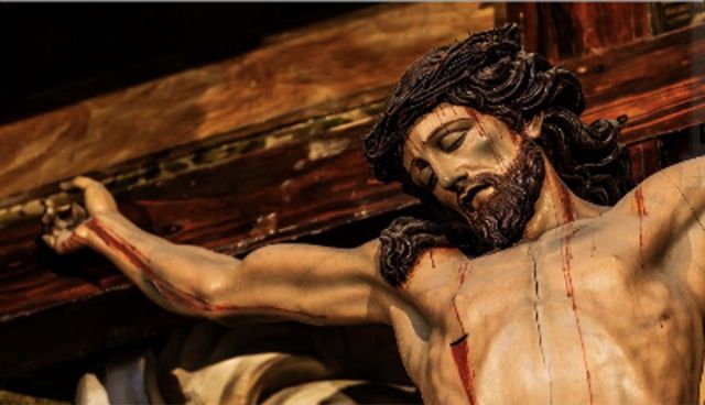 A church statue of Christ bleeding on the cross