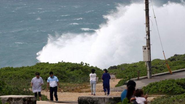 People watch as high waves generated by typhoon Haishen hit the village of Yomitan, Japan. Photo: 6 September 2020