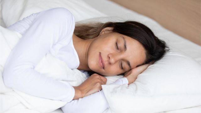 A woman sleeping on a foam mattress (stock photo)