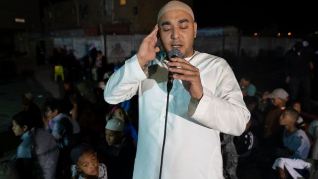 A man calls on Muslims to pray in Mannenburg, Cape Town - South Africa