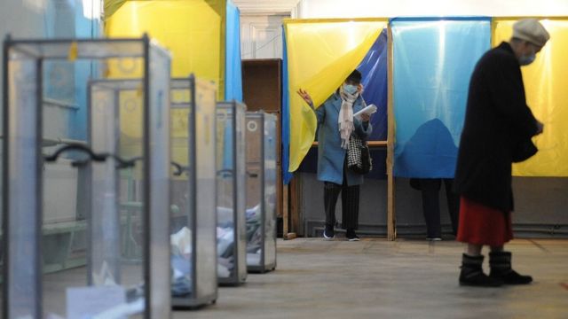 Women near voting booths
