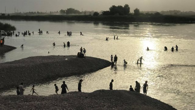 People swimming in river