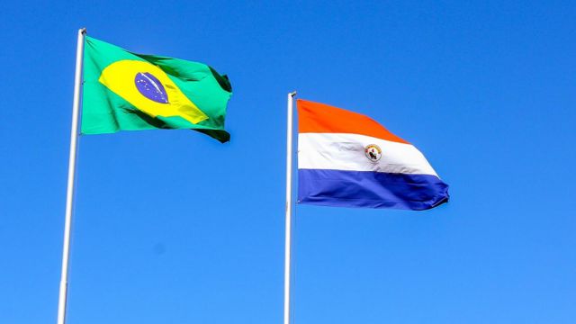 The flags of Brazil and Paraguay are flying