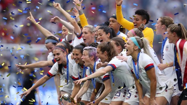 Megan Rapinoe of the USA lifts the FIFA Women's World Cup Trophy following her team's victory in the 2019 FIFA Women's World Cup France Final match between The United States of America and The Netherlands at Stade de Lyon on July 07, 2019 in Lyon, France.