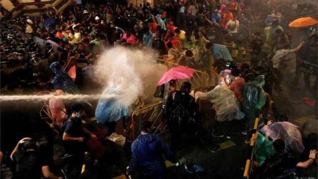 A person is hit with water from the water cannon during an anti-government protest in Bangkok, Thailand, October 16, 2020