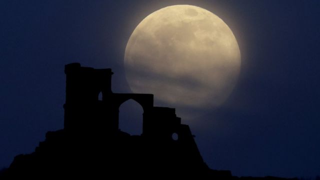 The supermoon rises over Mow Cop in Staffordshire