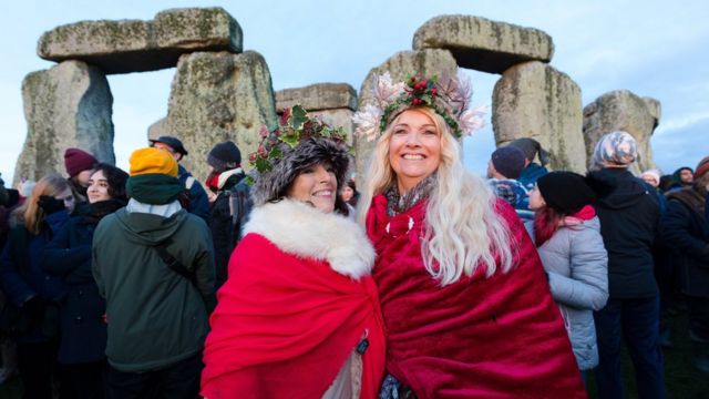 Revellers take part in the winter solstice celebrations at the ancient Stonehenge monument in Wiltshire, Britain, 22 December 2019.