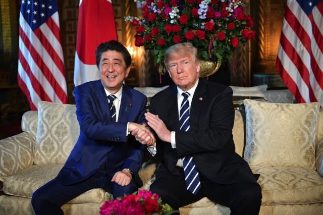US President Donald Trump greets Japanese Prime Minister Shinzo Abe as he arrives for talks at Trump's Mar-a-Lago resort in Palm Beach, Florida, on April 17, 2018.