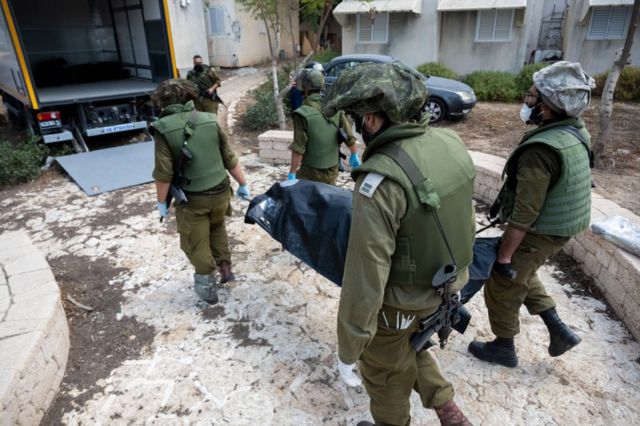 Израильские солдаты выносят тело 