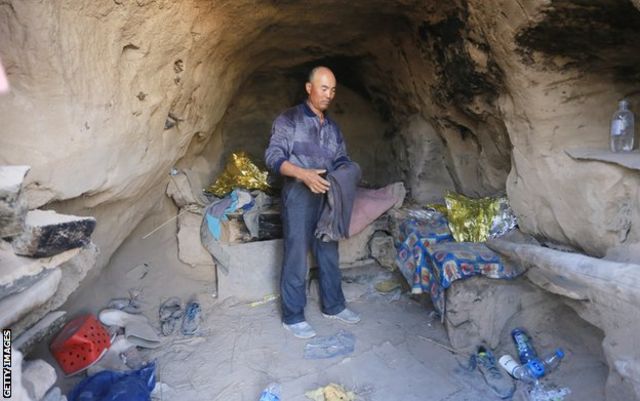 Shepherd Zhu Keming speaks to the media in a cave, where he saved the lives of runners during a mountain ultramarathon on last Saturday, on May 24, 2021 in Baiyin, Gansu province