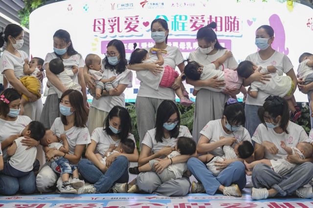 Twenty mothers breastfeed their children during a flash mob event to raise public awareness of breastfeeding at a subway station on 31 July 2020 in Guangzhou, Guangdong Province of China. 