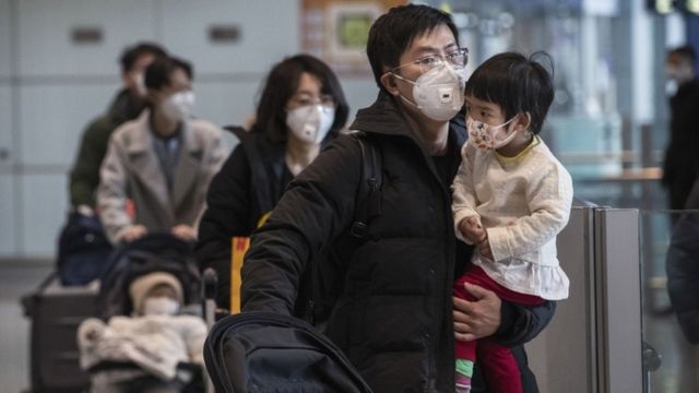 Passengers wear protective masks in Beijing Capital Airport on January 30, 2020