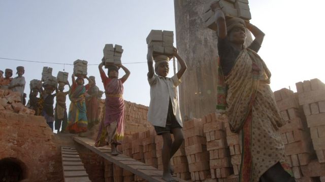 Children in Bangladesh carying bricks on their heads