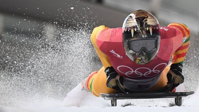 Ghana's Akwasi Frimpong slows down at the end of the men's skeleton heat 1 during the Pyeongchang 2018 Winter Olympic Games, at the Olympic Sliding Centre on February 15, 2018 in Pyeongchang