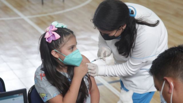Niña recibiendo una vacuna en Cuenca, Ecuador.