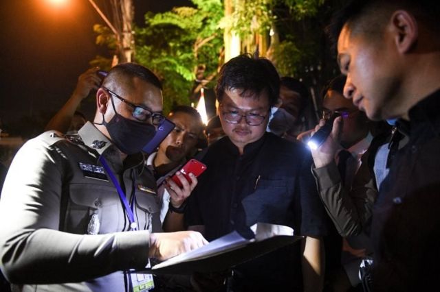 Anon Nampa, one of the leaders of recent anti-government protests, is detained by a police outside the criminal court in Bangkok, Thailand August 19, 2020.