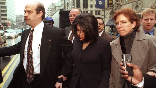 Monica Lewinsky, with her head down, being escorted in 1998 archive shot