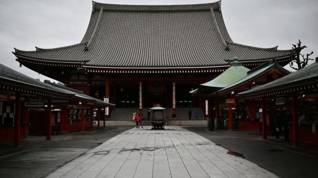 A small number of tourists visit the nearly empty Sensoji temple in Tokyo's Asakusa district on March 9, 2020