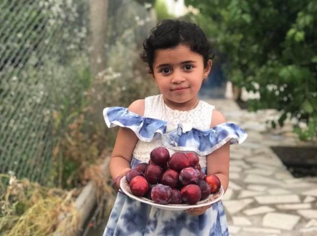 Girl with plums