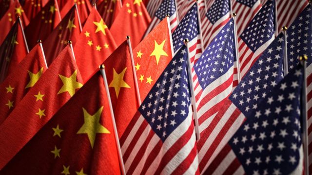 Multiple Chinese flags (left) and American flags (right)
