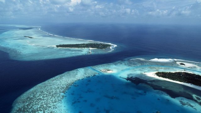 Aerial view of a chain of atolls in the Maldives, Indian Ocean