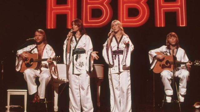 The entire ABBA group on stage singing.