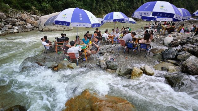 Mahjong players in a river