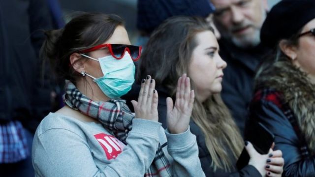 A fan wears a face mask inside Murrayfield Stadium in Edinburgh during a Six Nations match