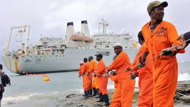 Workers haul a fibre-optic cable, which will serve East Africa, to shore at the Kenyan port town of Mombasa in 2009
