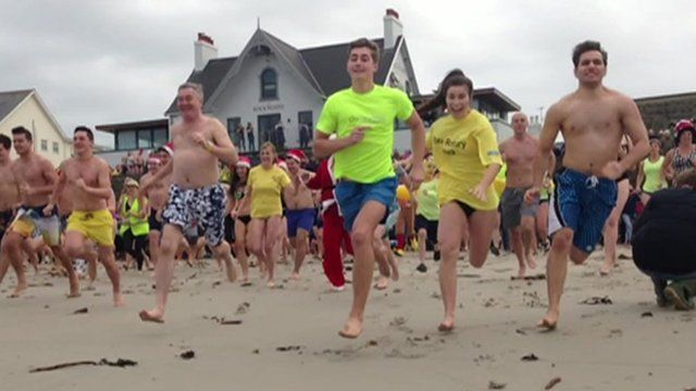 Swimmers running into the sea in Guernsey