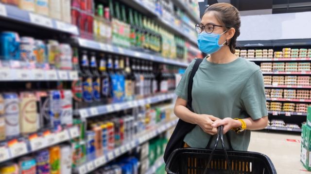 Mulher comprando cerveja em um supermercado