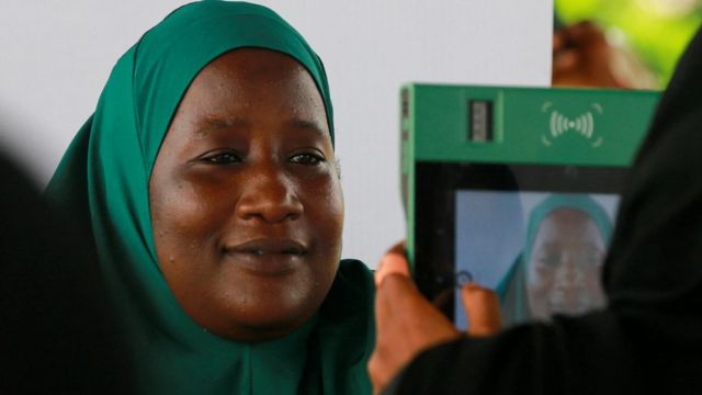 A woman in green hijab