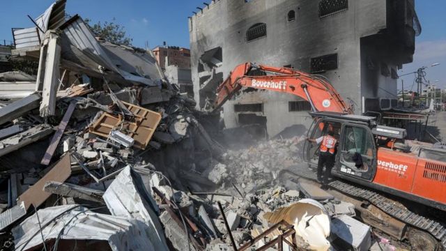 Palestinians search for victims and survivors in the rubble of Al-Naqeeb family house leveled in an Israeli airstrike in Al Nusairat, central Gaza Strip, 16 October 2023