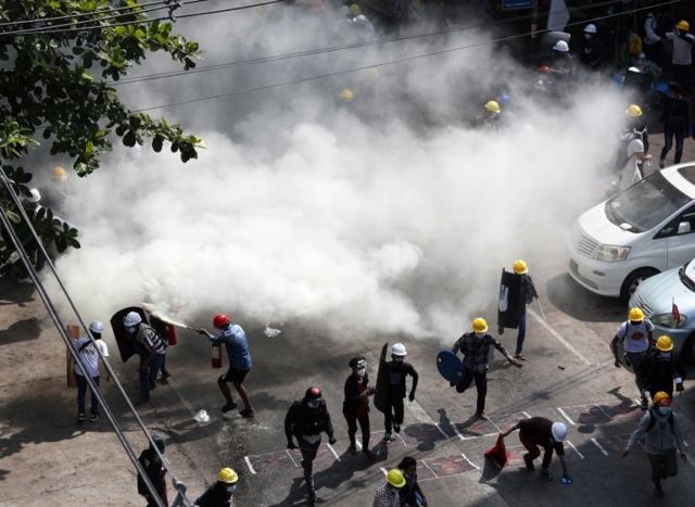 White smoke and protesters