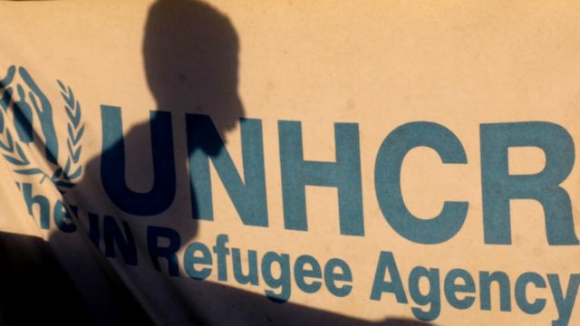 Shadow of a displaced Syrian child is silhouetted on a UNHCR tent at a camp in the village of Ain Issa on July 11, 2017
