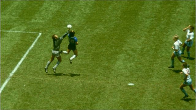 Argentina player Diego Maradona outjumps England goalkeeper Peter Shilton to score with his 'Hand of God' goal