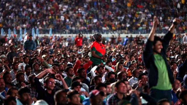 Doha workers and Football fans watch the match between Portugal and Ghana at the Industrial Area Fan Zone in the Asian Town Cricket Stadium