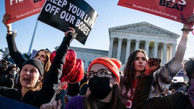 Pro-life and pro-choice protestors gather outside the Supreme Court as arguments begin about the Texas abortion law by the court on Capitol Hill