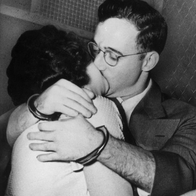 Julius and Ethel Rosenberg, handcuffed, kiss in the back of a prison van after their treason arraignment, New York City, 1950.