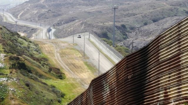 A stretch of wall runs along the US-Mexican border