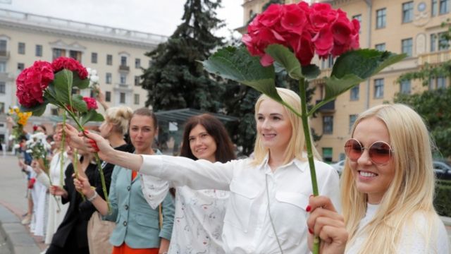 Women hold flowers during a demonstration against violence following recent protests to reject the presidential election results in Minsk, Belarus August 20, 2020