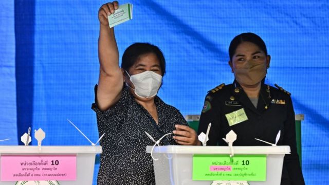 A woman casts her ballot at a polling station during Thailand's general election in Bangkok on May 14, 2023