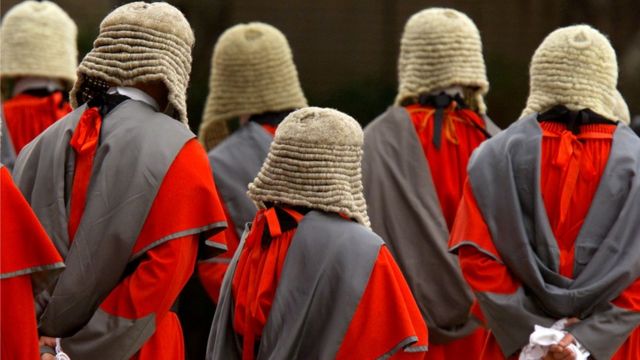 Supreme court judges wearing wigs attend a ceremony to mark the beginning of the new legal year in Hong Kong January 14, 2002. REUTERS/Bobby Yip/File Photo